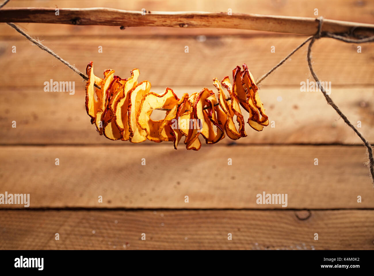 Dried apple slices and wooden backdrop Stock Photo