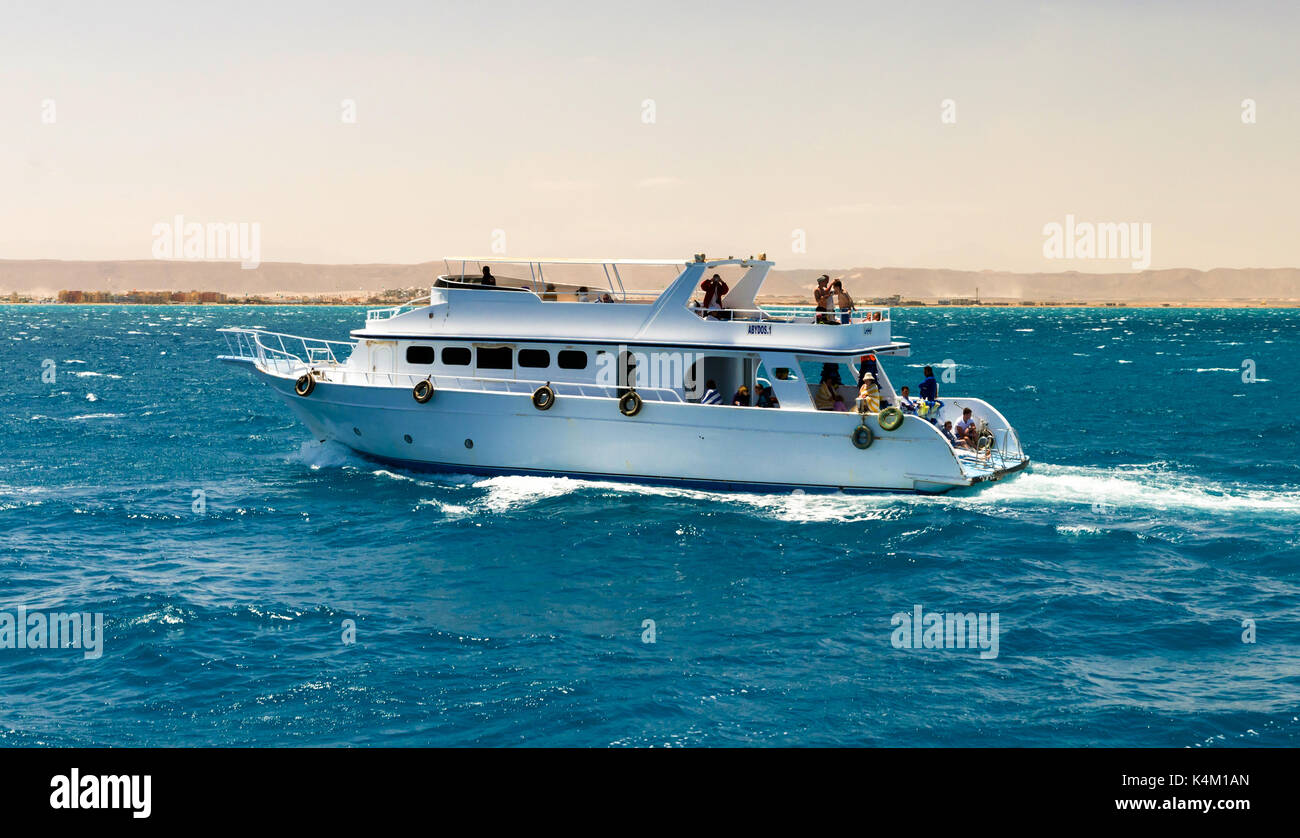 Hurghada, Egypt - April 11, 2015: Here comes a lot of tourists on yachts and boats to swim, sunbathe, go diving and have a good time Stock Photo