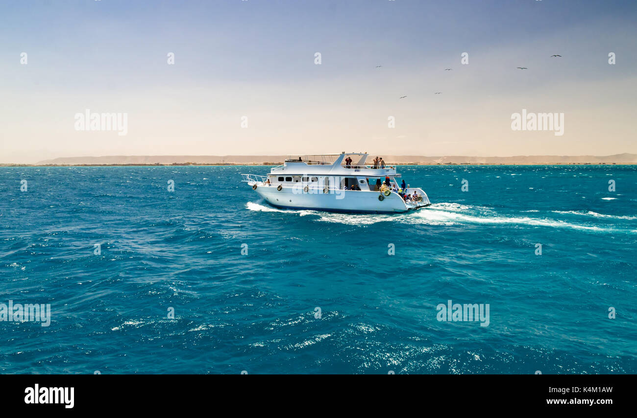 Hurghada, Egypt - April 11, 2015: Here comes a lot of tourists on yachts and boats to swim, sunbathe, go diving and have a good time Stock Photo