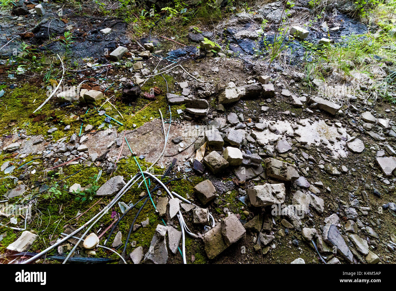 Rubble on the ground with broken bricks and stones and wires Stock Photo