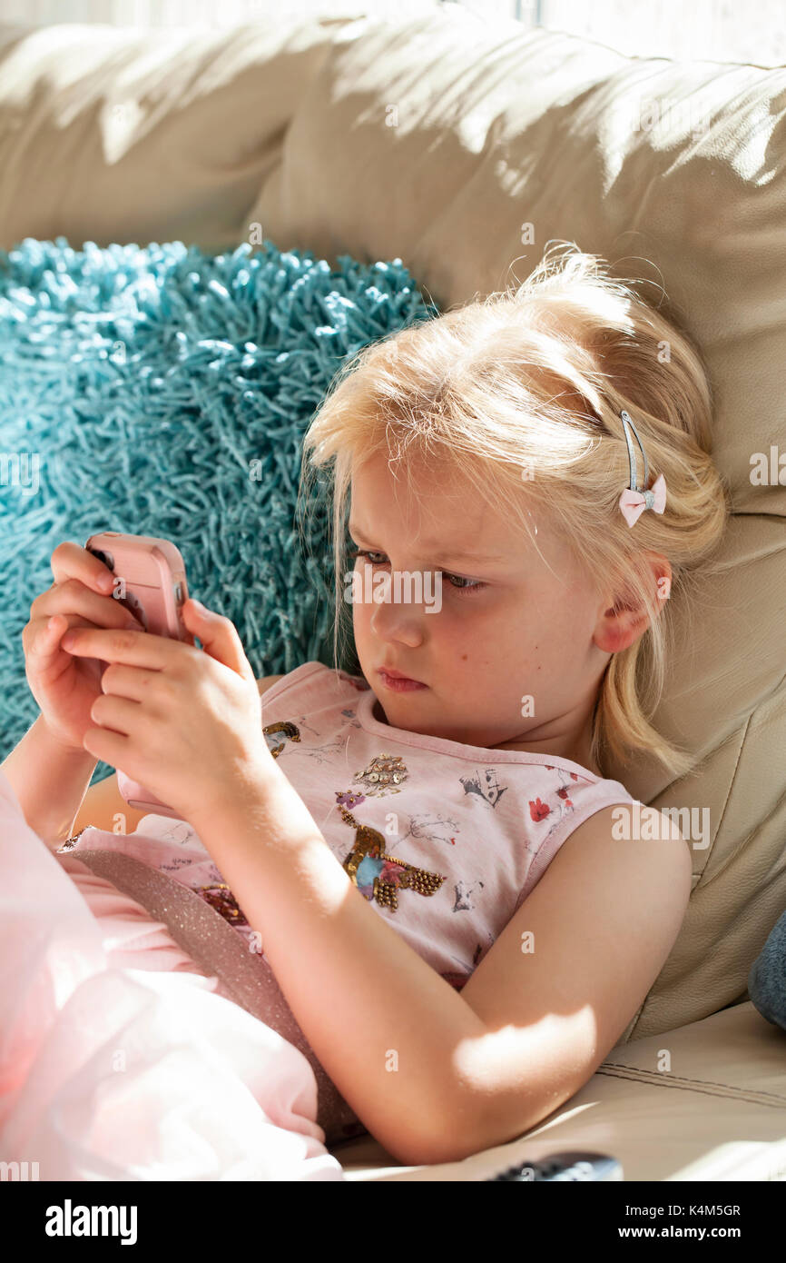 Little girl playing with smart phone Stock Photo