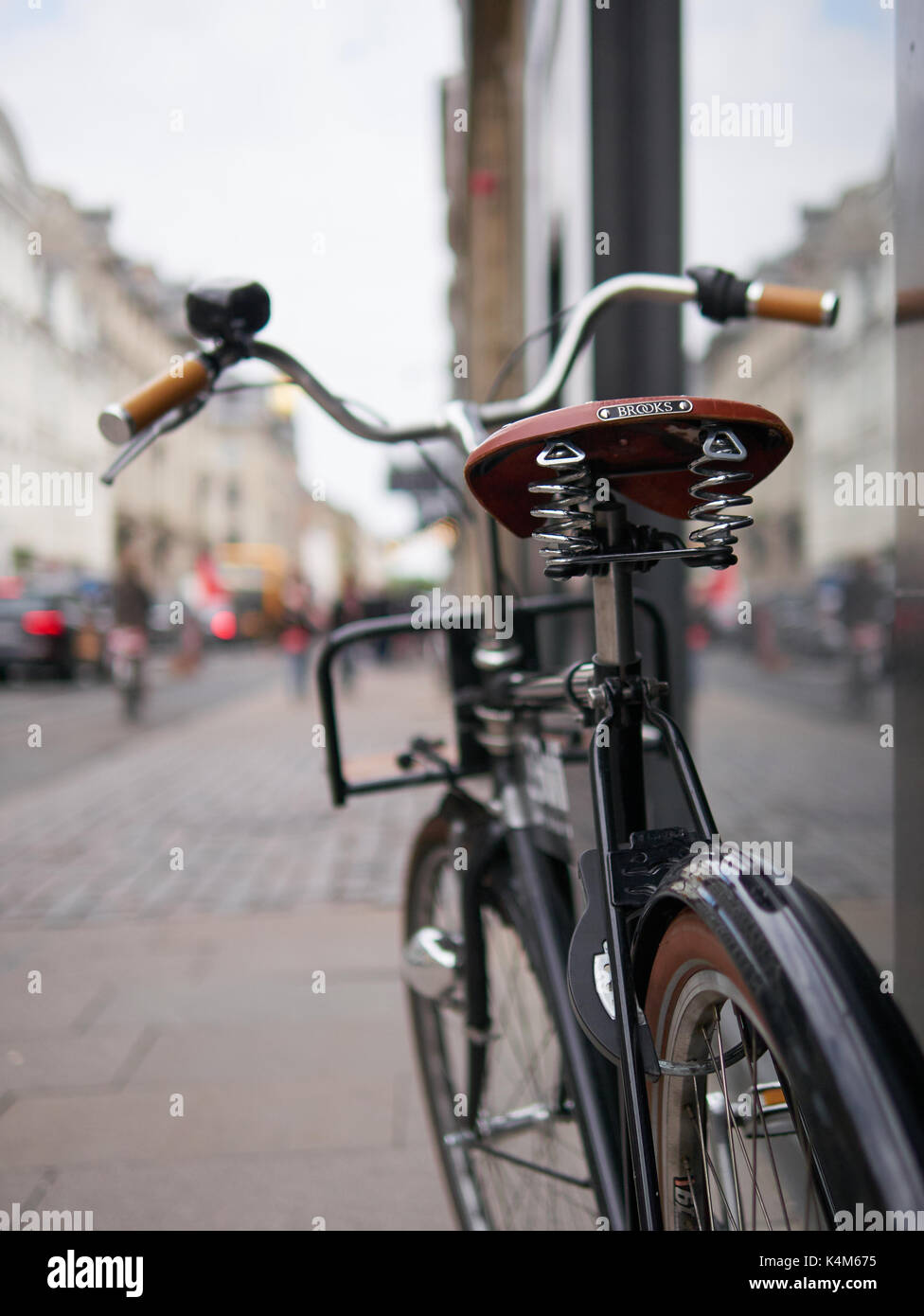 Classic bicycle parked in the street along a central street of Copenhagen Stock Photo