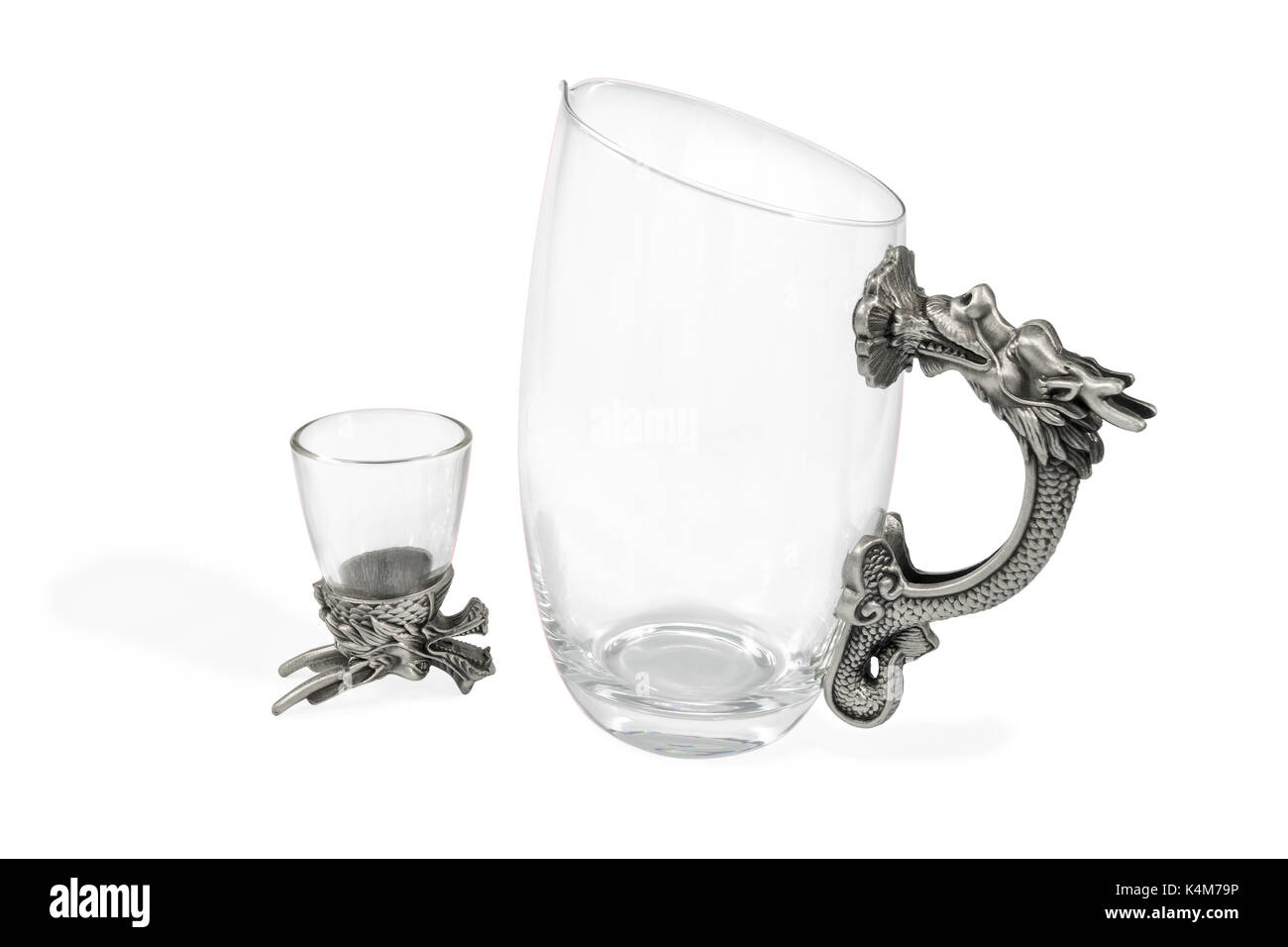 Art set of decanter and wine glasses for vodka with a handle and a bottom in the form of a dragon, isolated on a white background Stock Photo