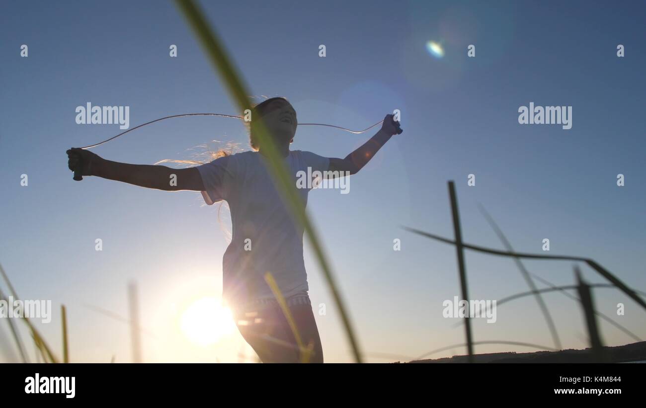 Woman jumping rope swing hi-res stock photography and images - Alamy