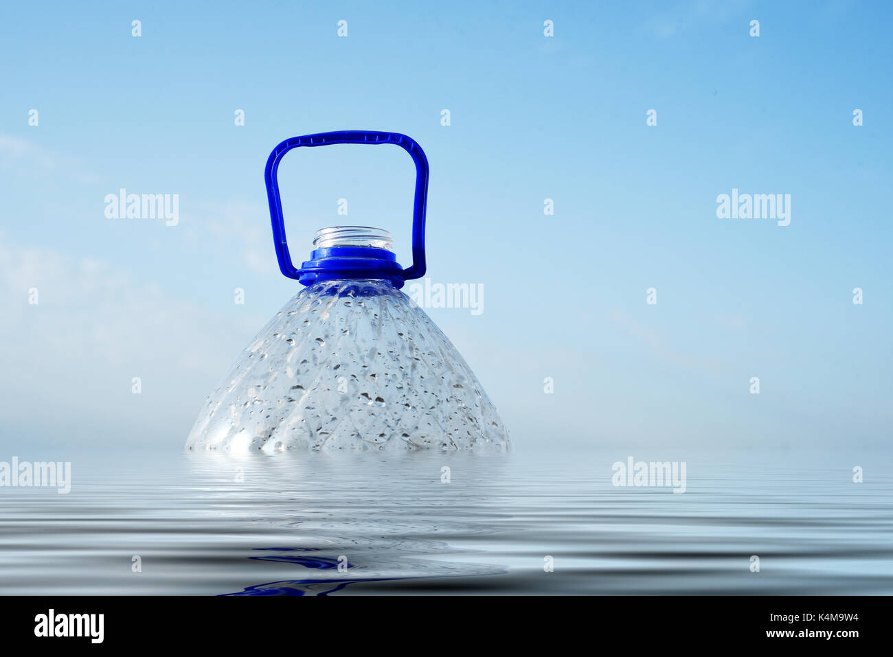 Plastic PET bottle floating in sea water partly submerged Stock Photo