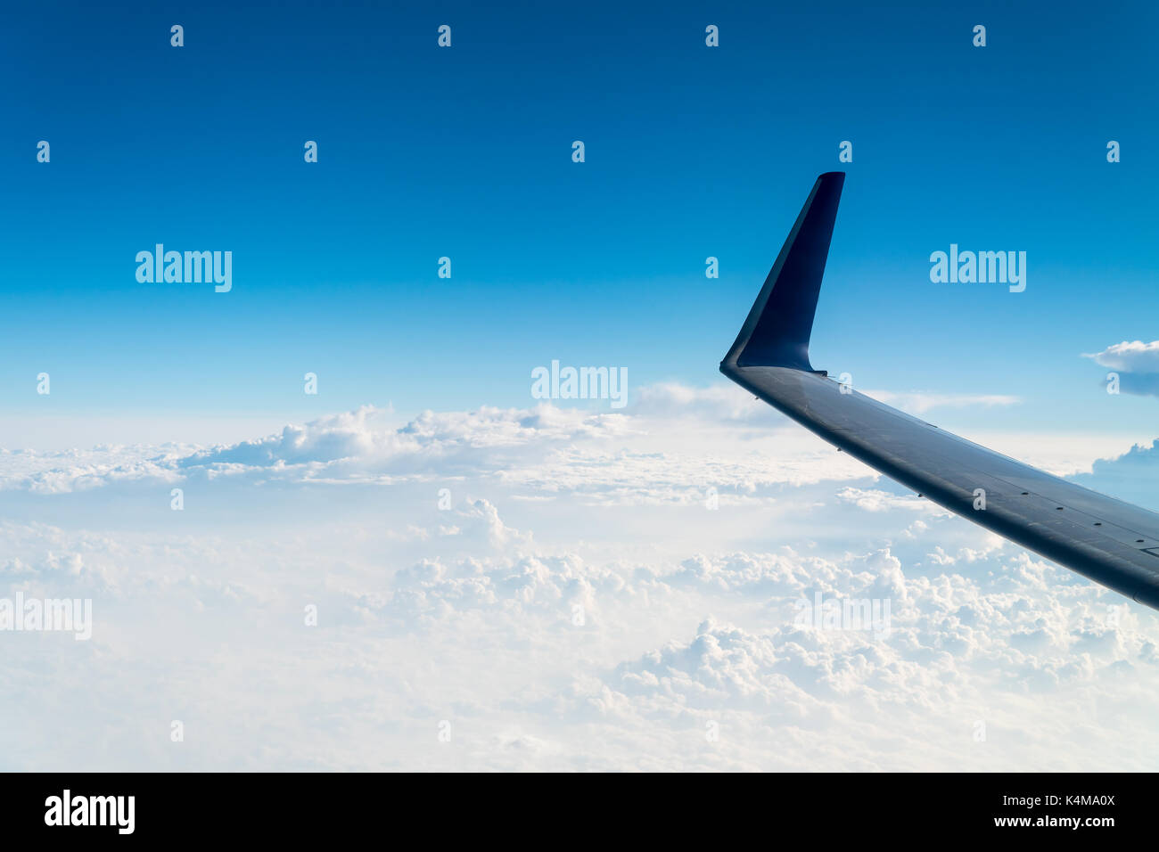 Airplane Wing View Above The Clouds Stock Photo - Alamy