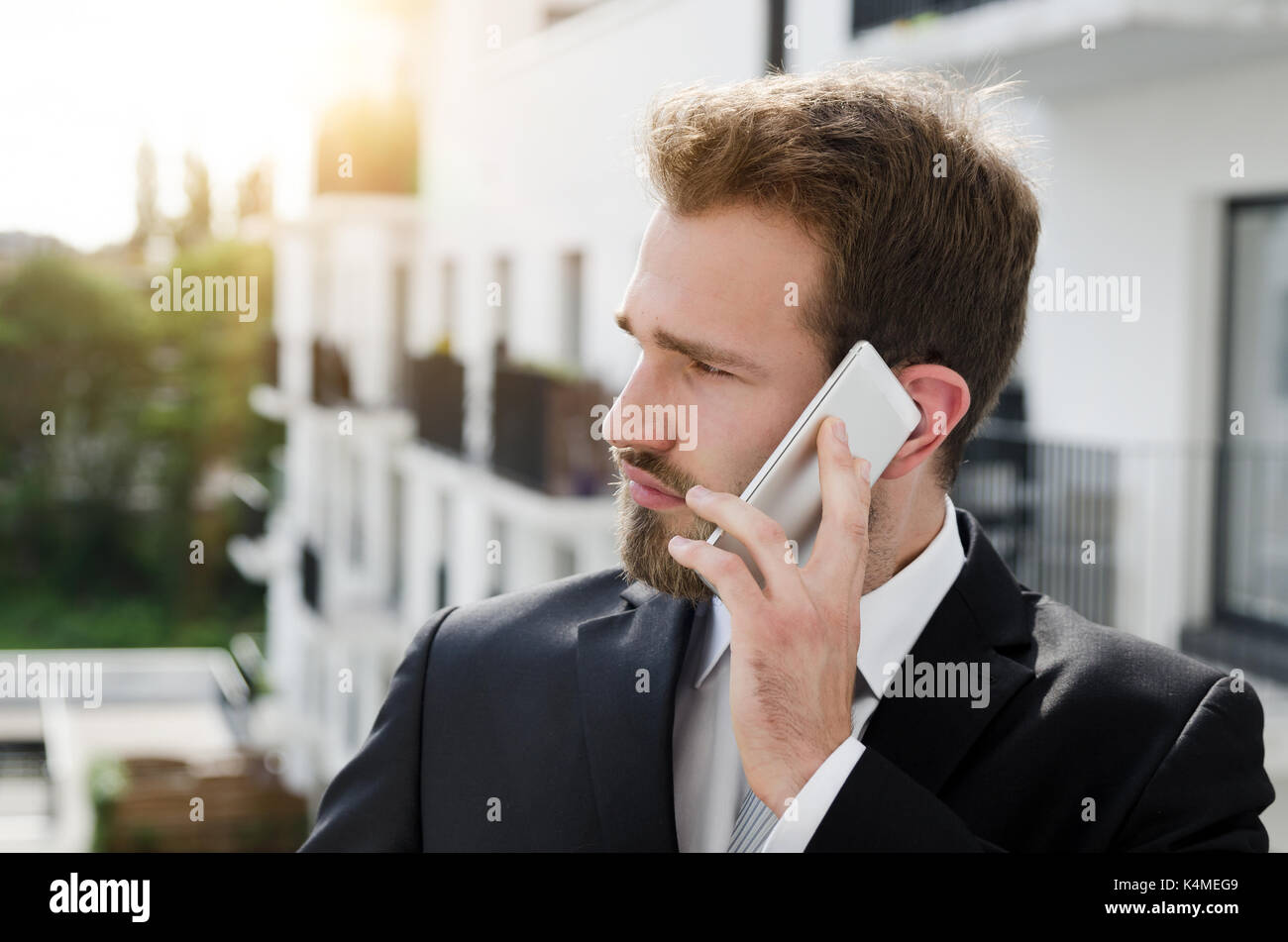 Handsome businessman talking on phone city outdoor. businessman phone architecture attractive building business working concept Stock Photo