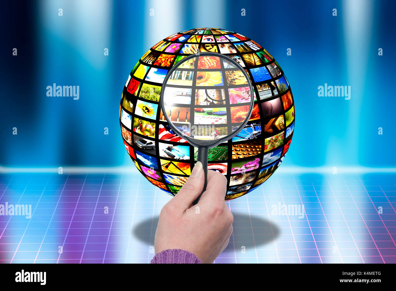 hand with magnifier and pictures on a sphere, image searching concept Stock Photo
