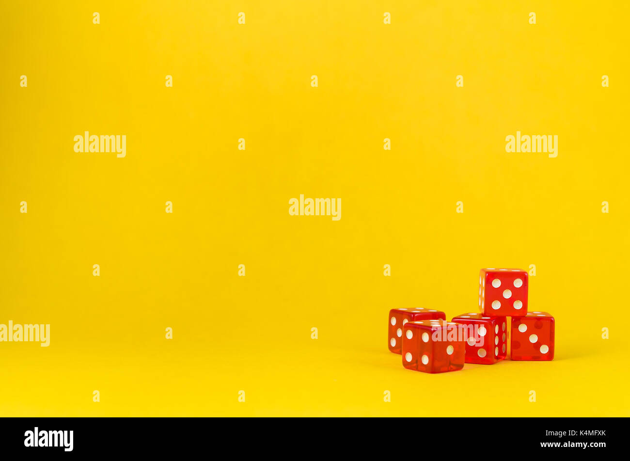 5 dice on yellow background, poker dice. Stock Photo