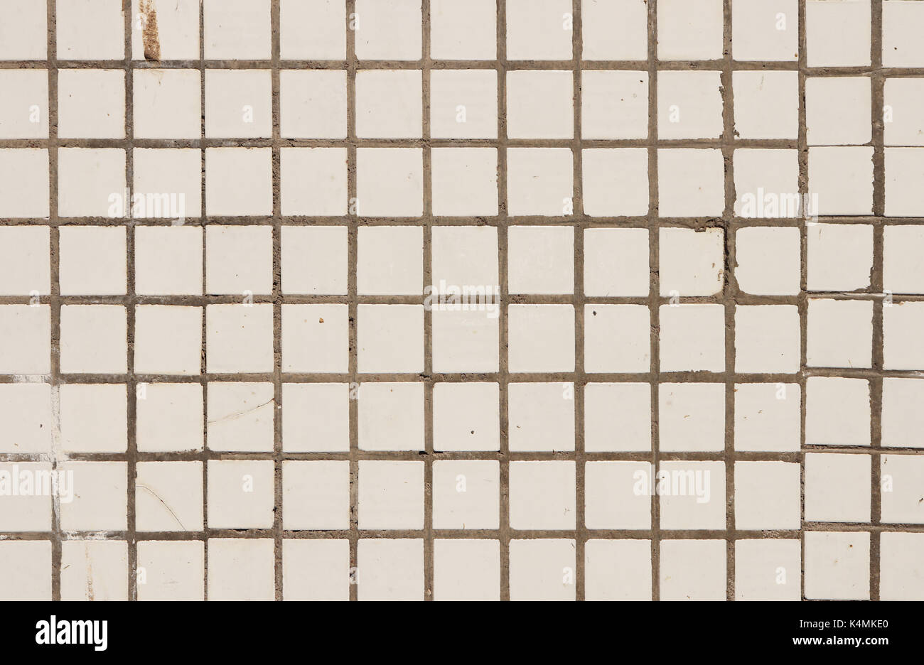 Small White Tiles Wall Texture. Urban Street Background. Stock Photo