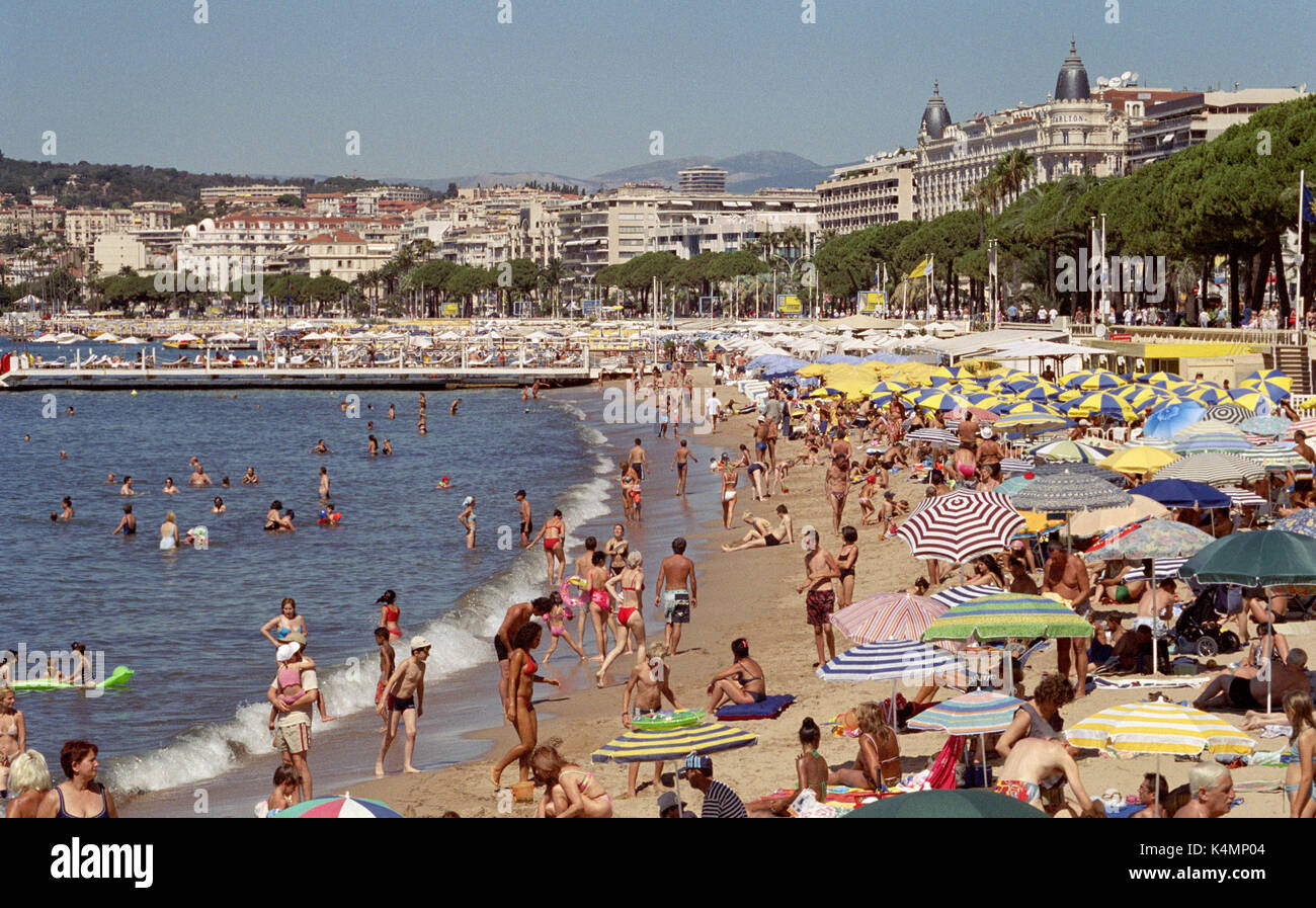 CANNES BEACH IN SUMMER -CANNES CROISETTE- CANNES FRENCH RIVIERA - PEOPLE ENJOYING SUN BATH AND SWIMMING AT CANNES BEACH-SILVER FILM© Frédéric BEAUMONT Stock Photo