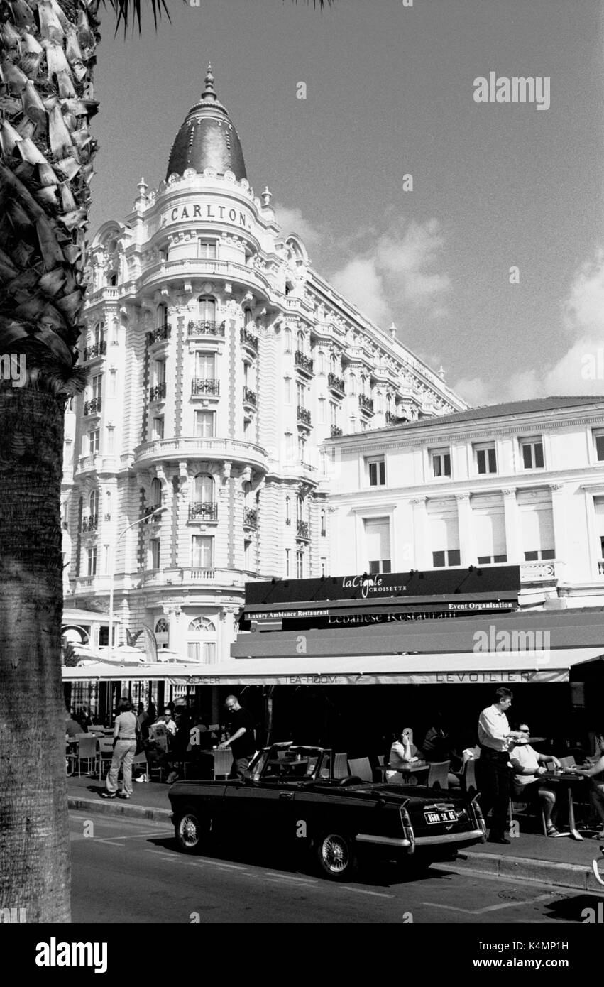 CANNES FRANCE - A TRIUMPH HERALD PARKED FRONT OF LE VOILIER RESTAURANT- CANNES LA CROISETTE - CANNES CARLTON HOTEL- SILVER FILM © Frédéric BEAUMONT Stock Photo