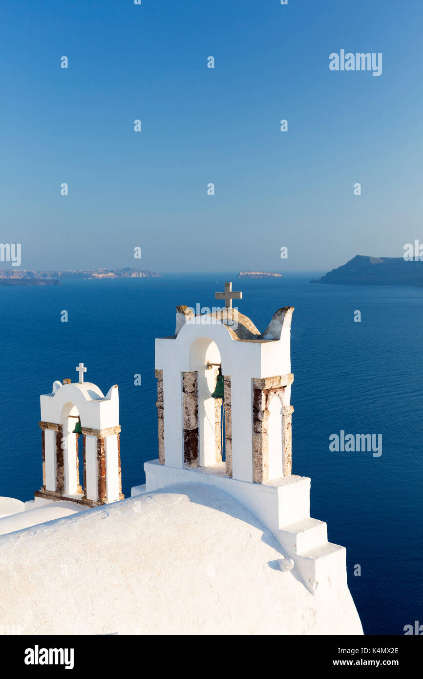 White church belltowers overlooking the Caldera, Oia, Santorini, Cyclades, Greek Islands, Greece, Europe Stock Photo