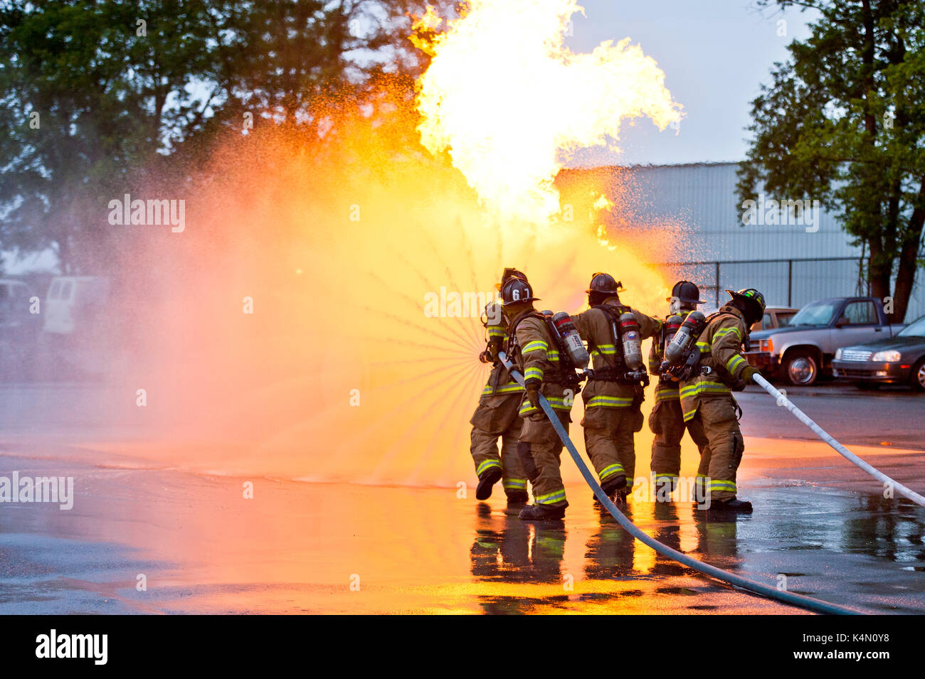 FIREFIGHTERS TRAINING WITH WATER HOSE TO PUT OUT TANK FIRES, LANCASTER PENNSYLVANIA Stock Photo