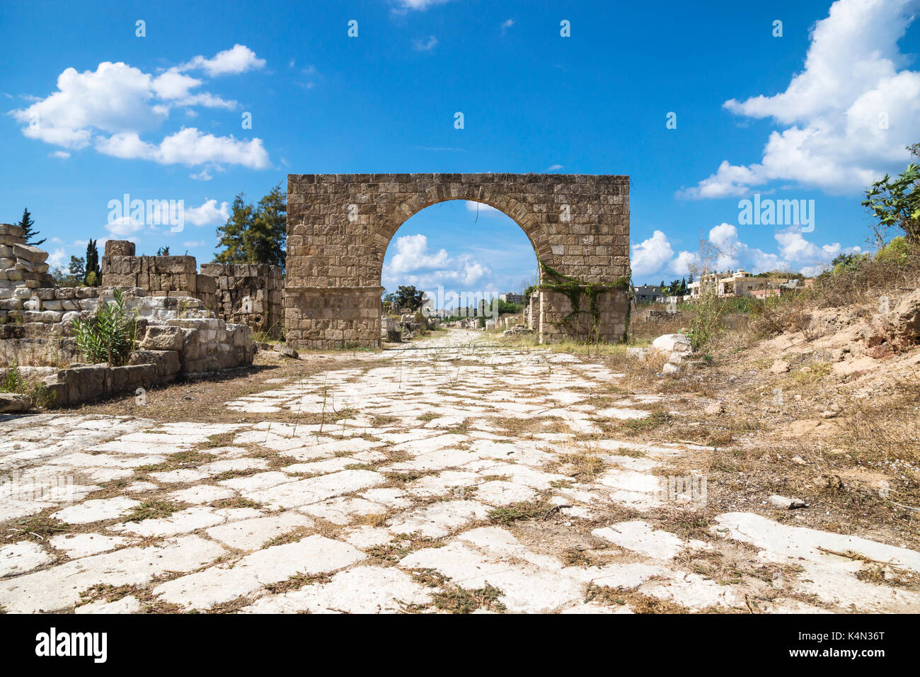 Byzantine road with triumph arch with blue sky in ruins of Tyre, Lebanon Stock Photo
