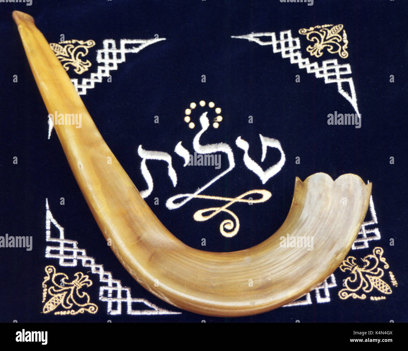 SHOFAR   (ram's horn) biblical wind instrument lying on ceremonial bag for prayer shawl (talit) Stock Photo
