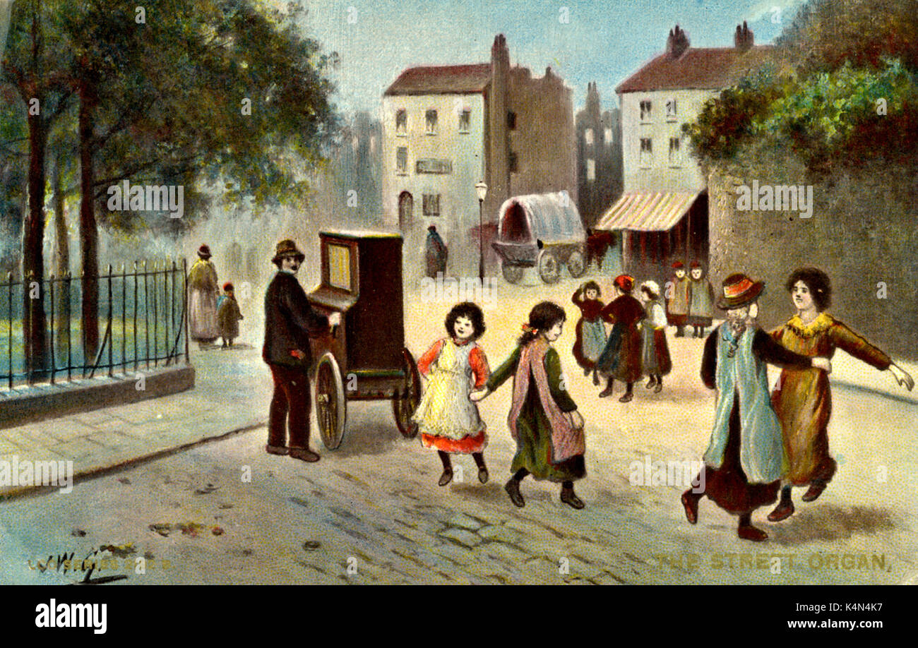 Barrel organ player  in  'The Street Organ' played by organ grinder, children dancing in the street. Turn of the 20th century Stock Photo