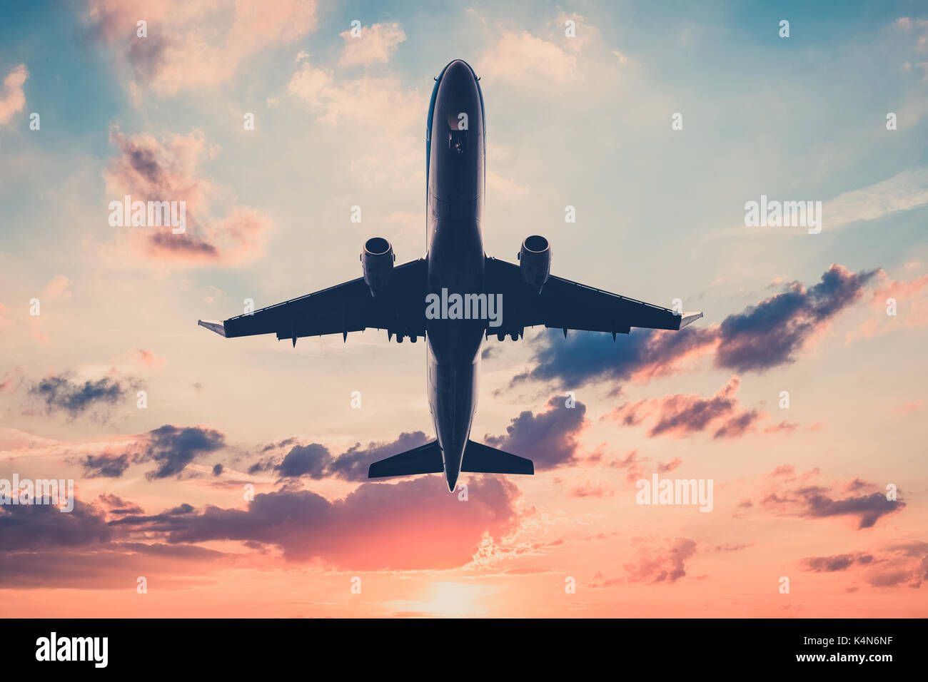jet, airplane on sunset sky  - scenic sky background Stock Photo