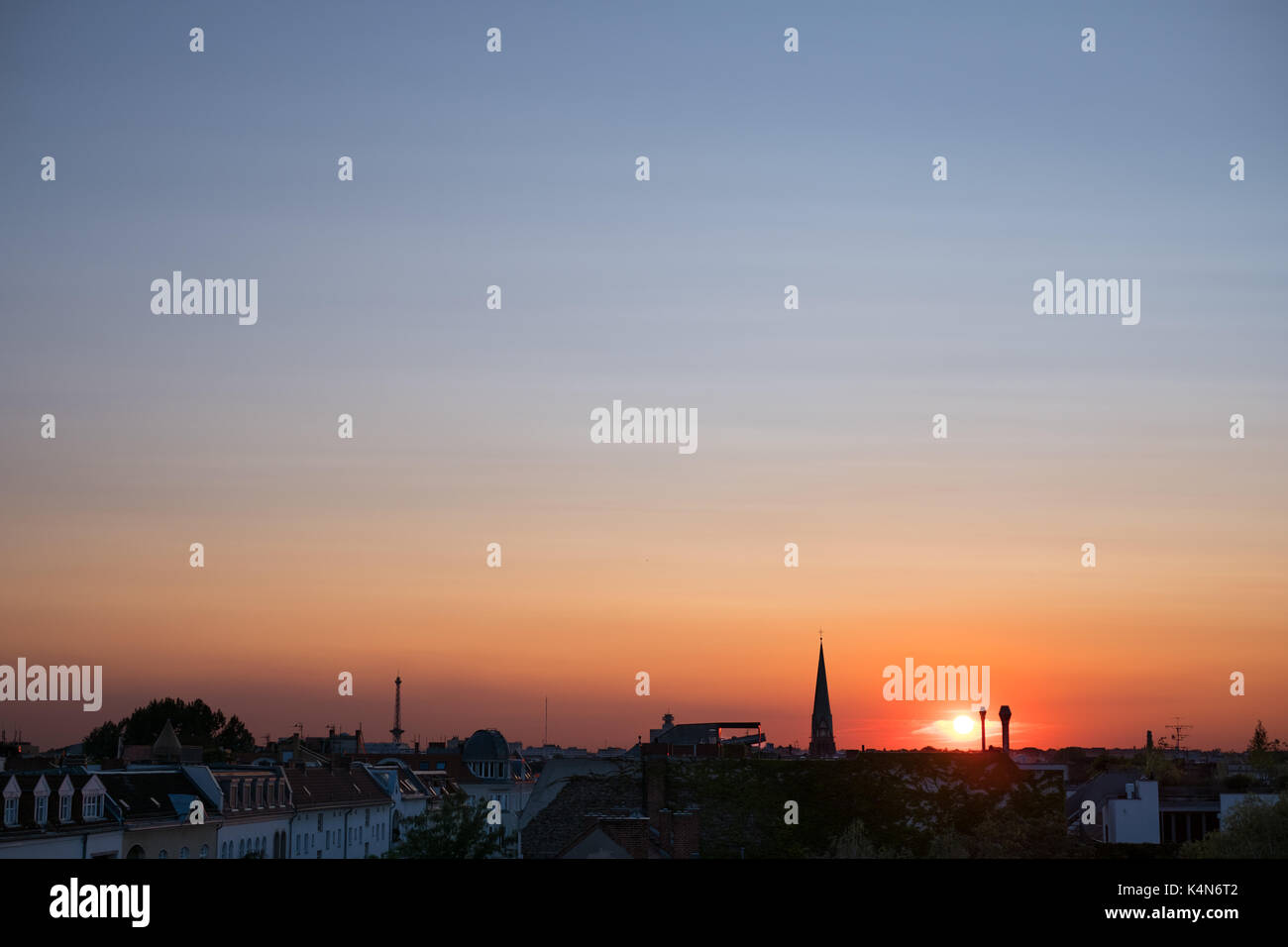 sunset sky over city - colorful sky panorama over rooftops Stock Photo