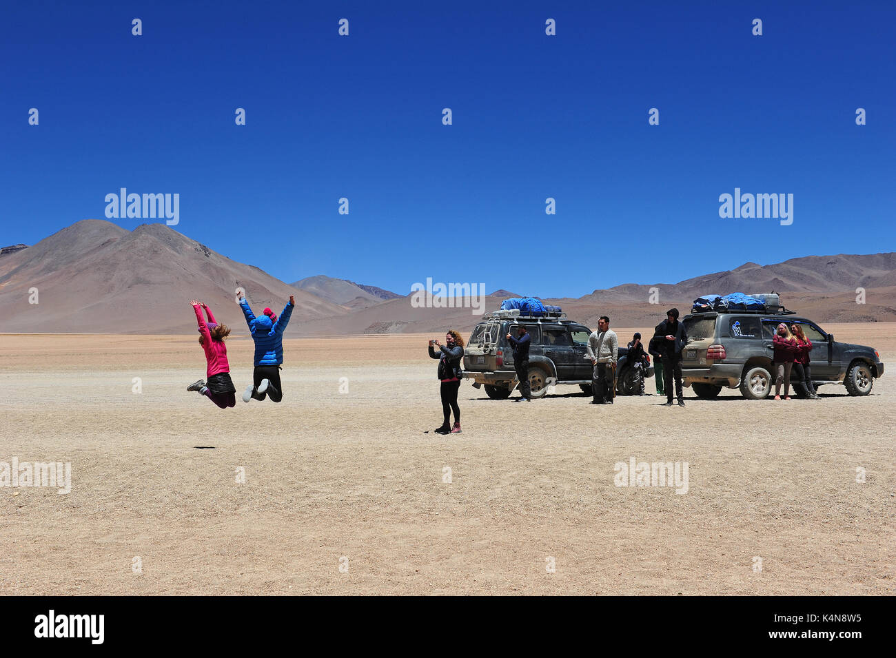 Tourists taking pictures on a jeep trip through Southern Bolivia Stock Photo