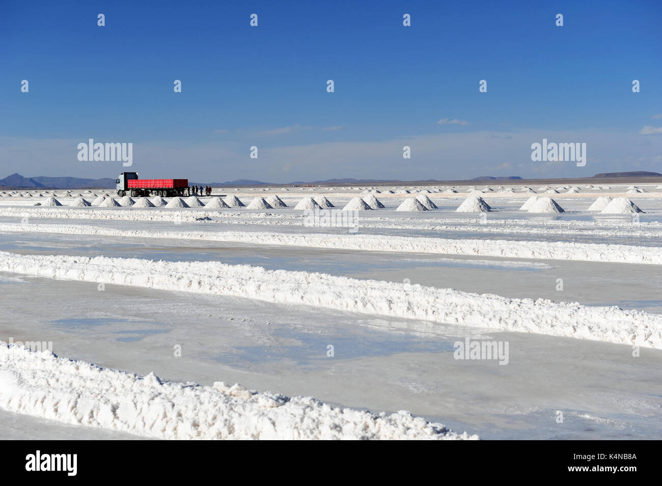 A truck near a series of salt cones in the Uyuni salt flats, Bolivia Stock Photo