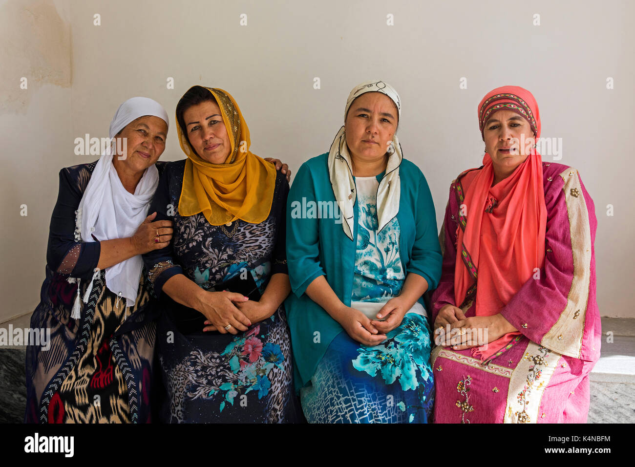 Four Uzbek musilim women dressed in traditional dresses headscarves in Samarkand, Uzbekistan Stock Photo