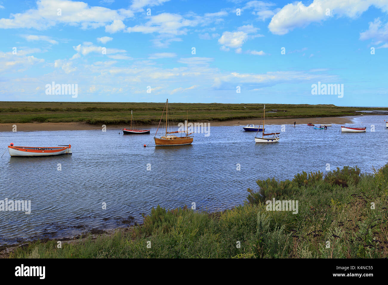 Boats on tidal moorings on the creek at Burnham-Overy-Staithe on the Norfolk coast, England, UK Stock Photo