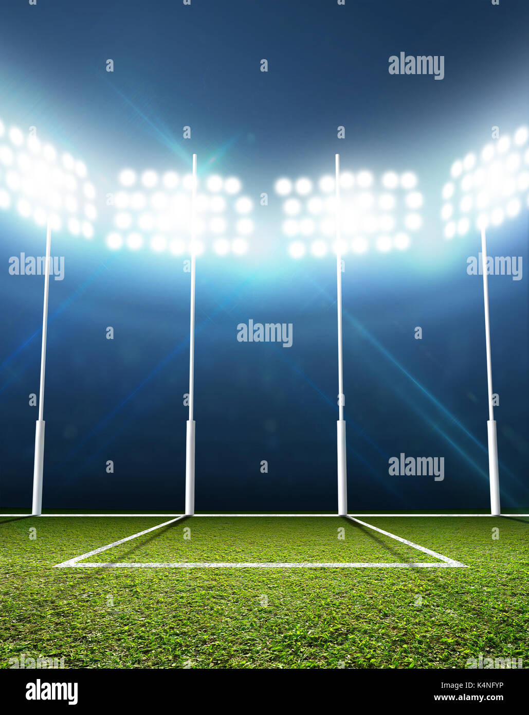 An aussie rules football stadium with a marked green grass pitch and goal posts in the nighttime under illuminated floodlights - 3D render Stock Photo
