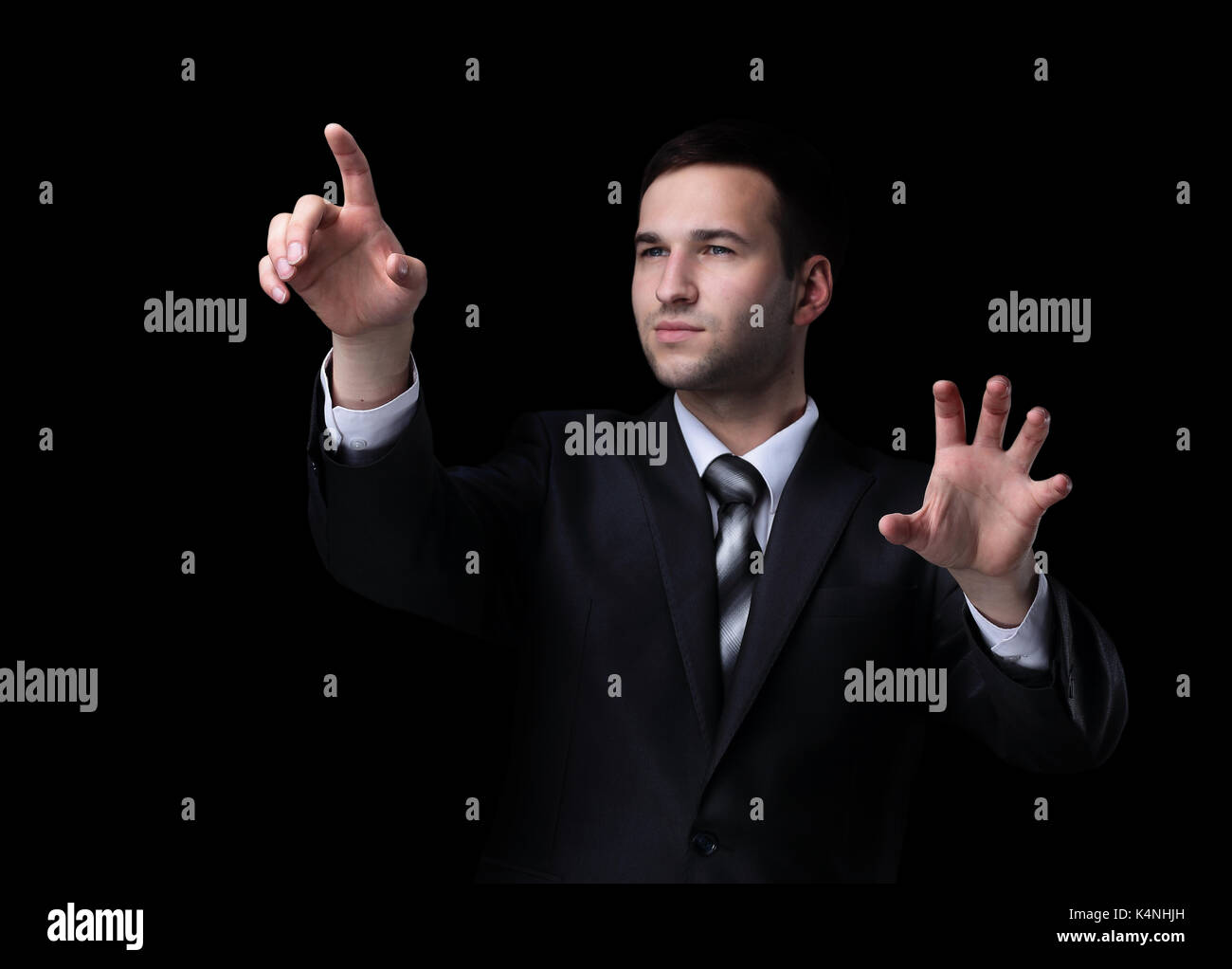 Business man pushing the imaginary  button. Isoladed on black. Stock Photo