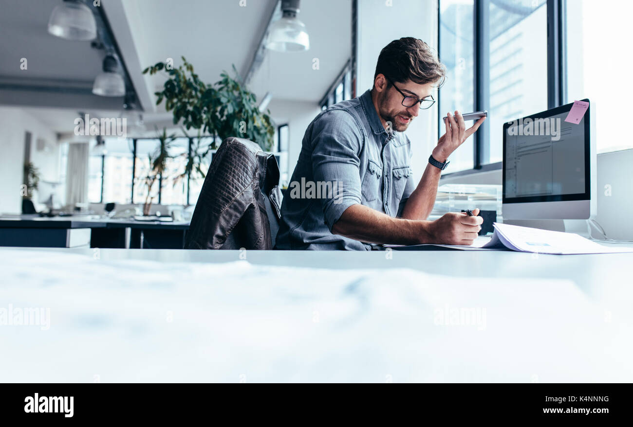 Businessman Holding Smart Phone And Working In Office Young Stock