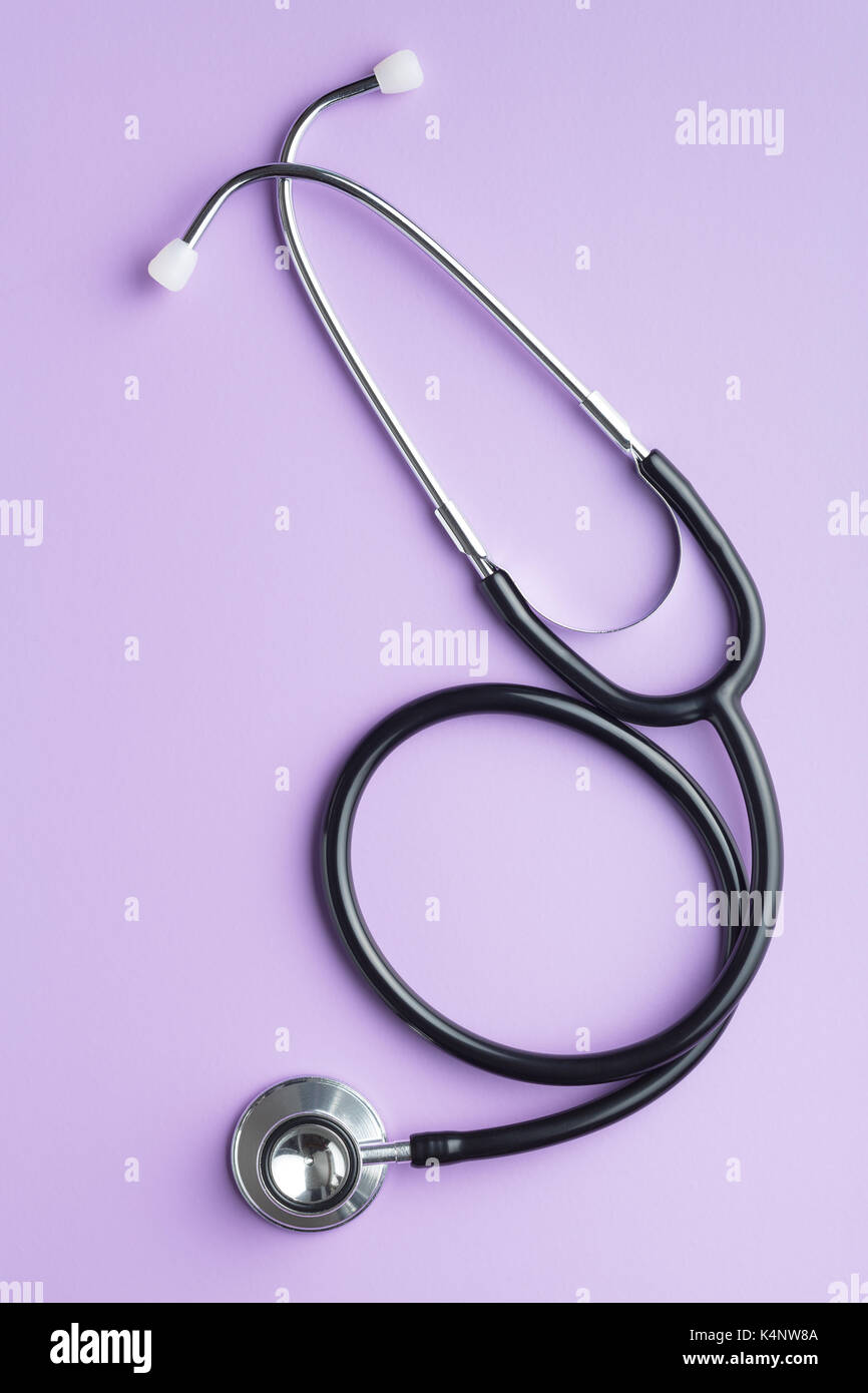 Black medical stethoscope on purple background. Stethoscope for listening  to the heart Stock Photo - Alamy