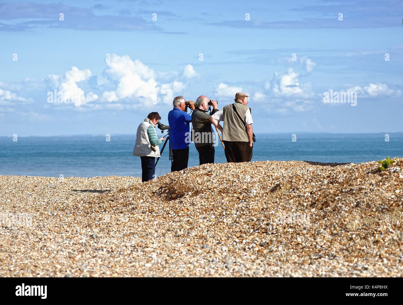 Bird spotters on Dungeness beach Kent UK Stock Photo