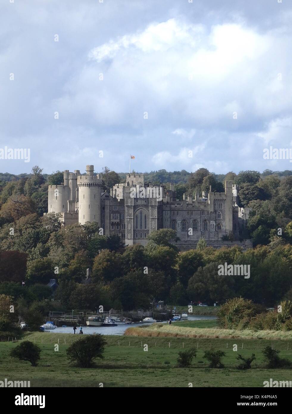 Arundel Castle in West Sussex Exterior with River Arun and boats moored in front; great day trip from London Stock Photo
