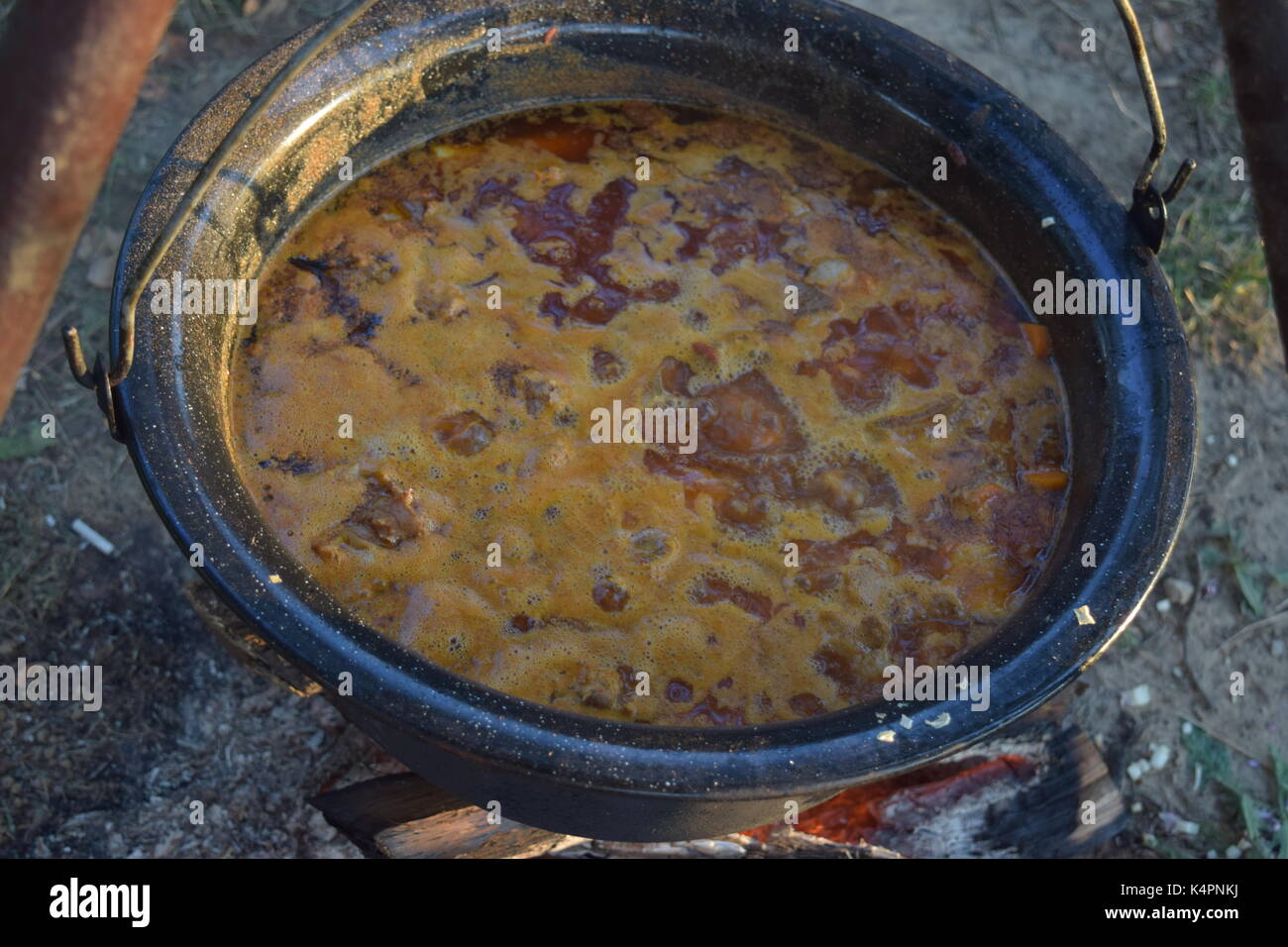 Cooking in a large pot, outside Stock Photo - Alamy