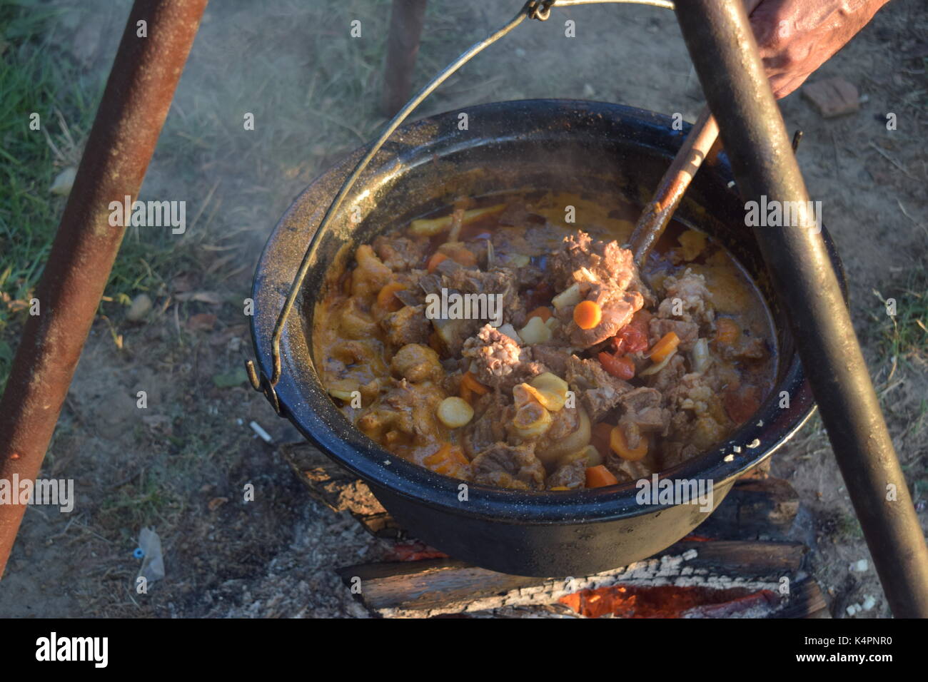 Cooking in a large pot, outside Stock Photo - Alamy