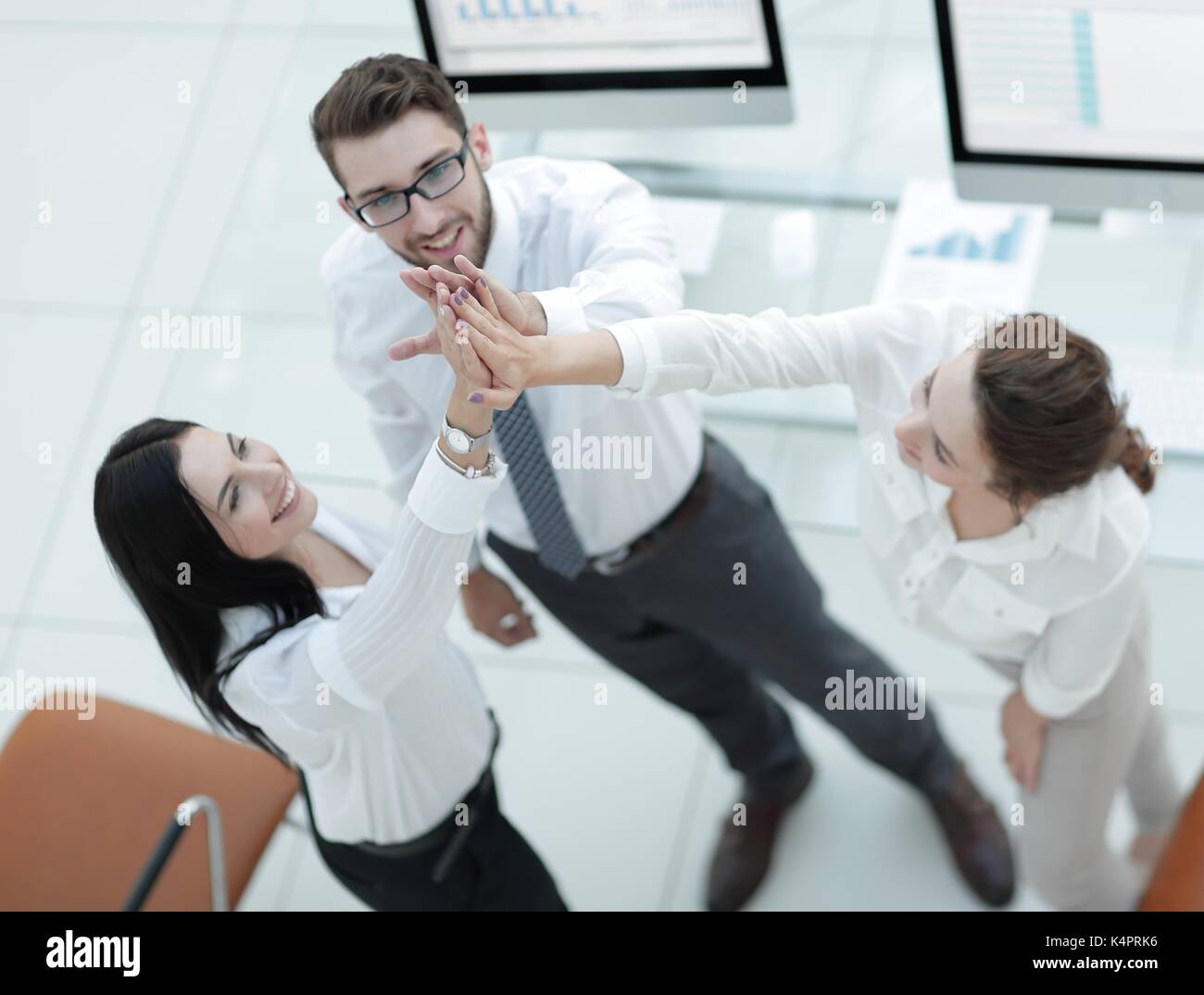 successful business team giving each other a high five Stock Photo - Alamy