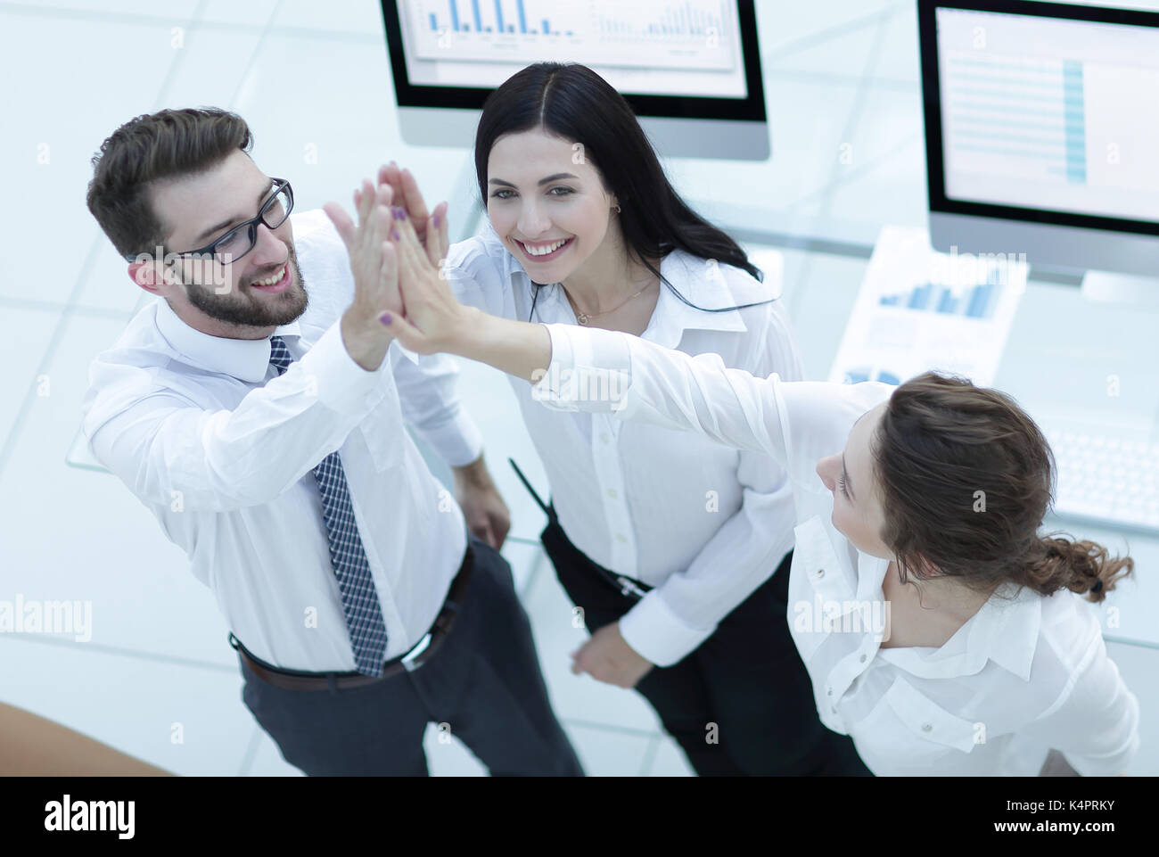 successful business team giving each other a high five Stock Photo - Alamy