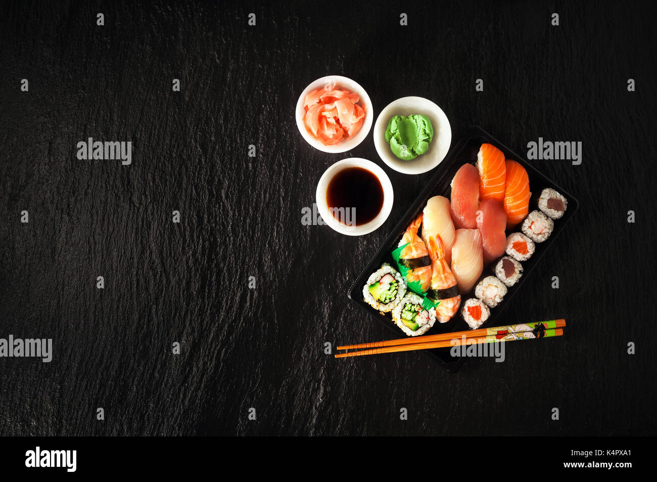 Sushi Set sashimi and sushi rolls served on stone slate Stock Photo