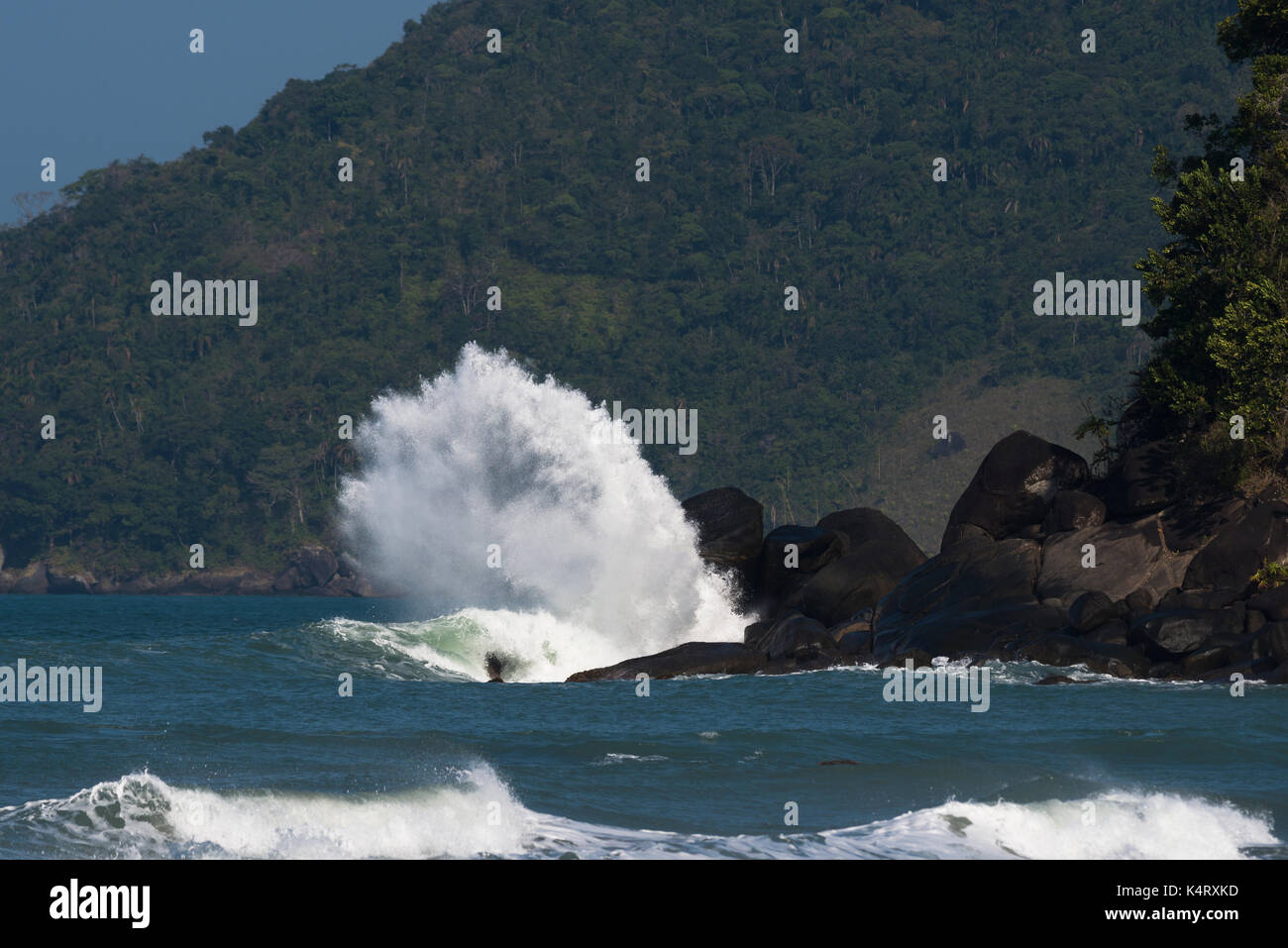 Wave crashing on a rock in Ilhabela, São Paulo, Brazil Stock Photo