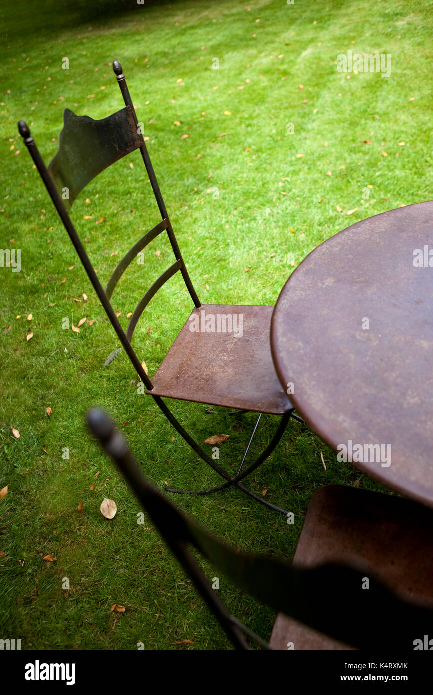 Metal garden furniture on a green garden Stock Photo Alamy