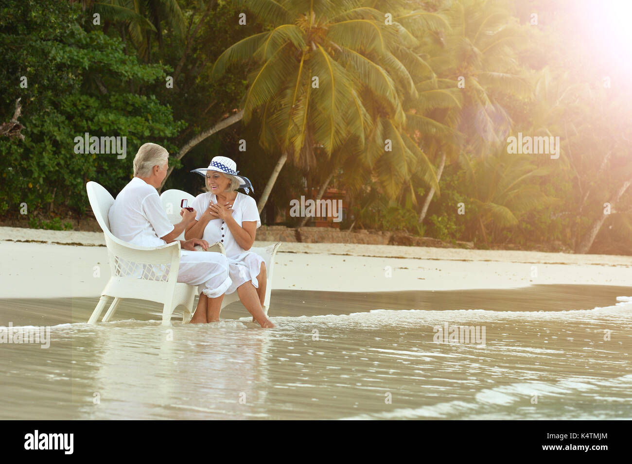 Senior couple resting on beach in chairs Stock Photo - Alamy