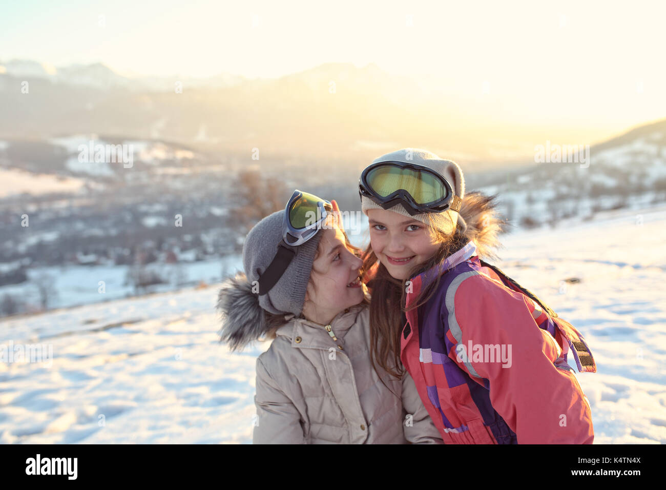 Happy girls have fun on the snow Stock Photo