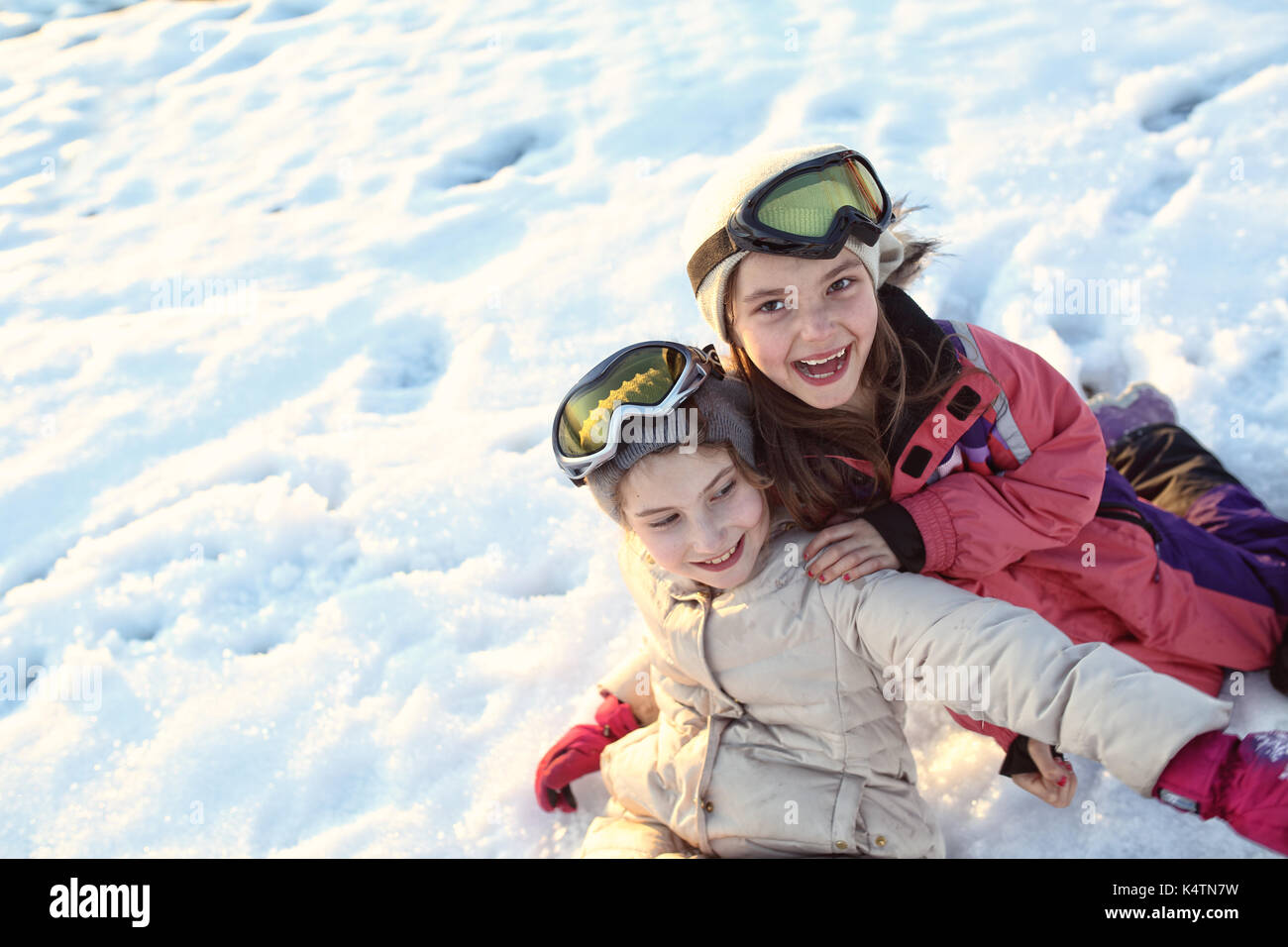 Young happy girls have fun on a winter sunny day Stock Photo