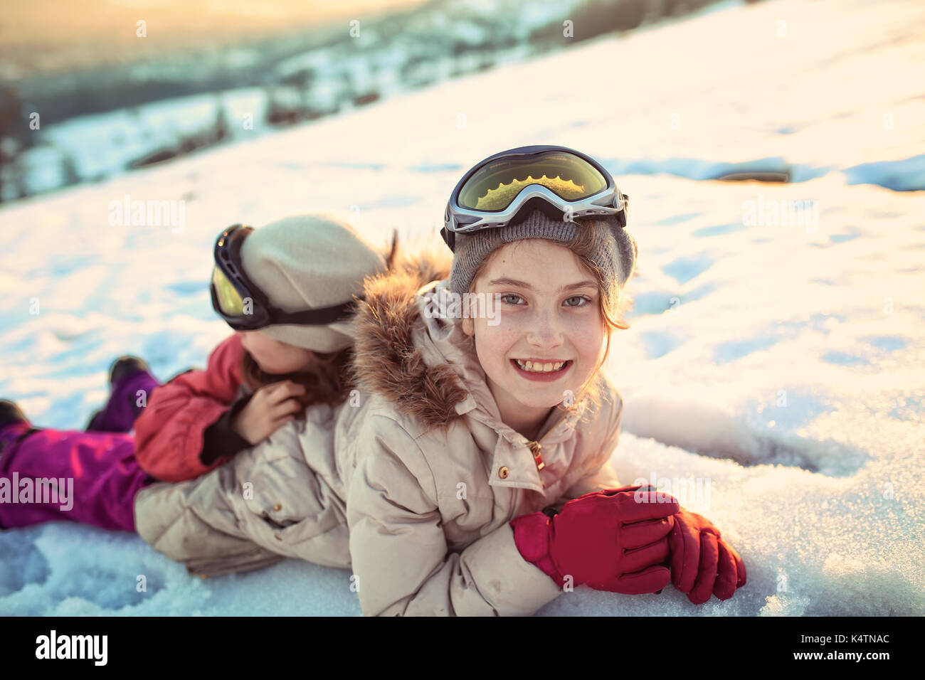 Happy girls have fun on the snow Stock Photo