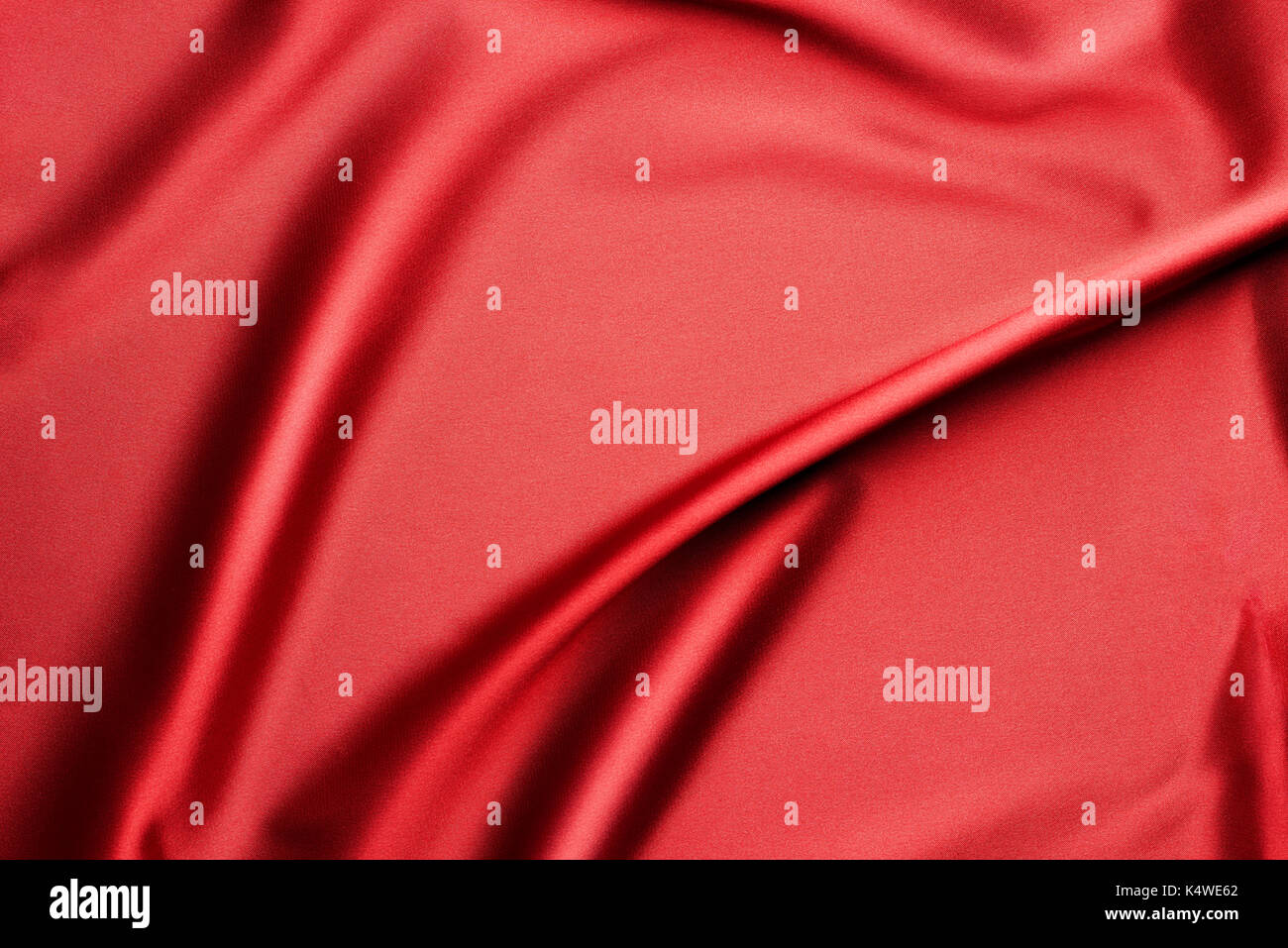 Rippled red silk fabric - texture background Stock Photo