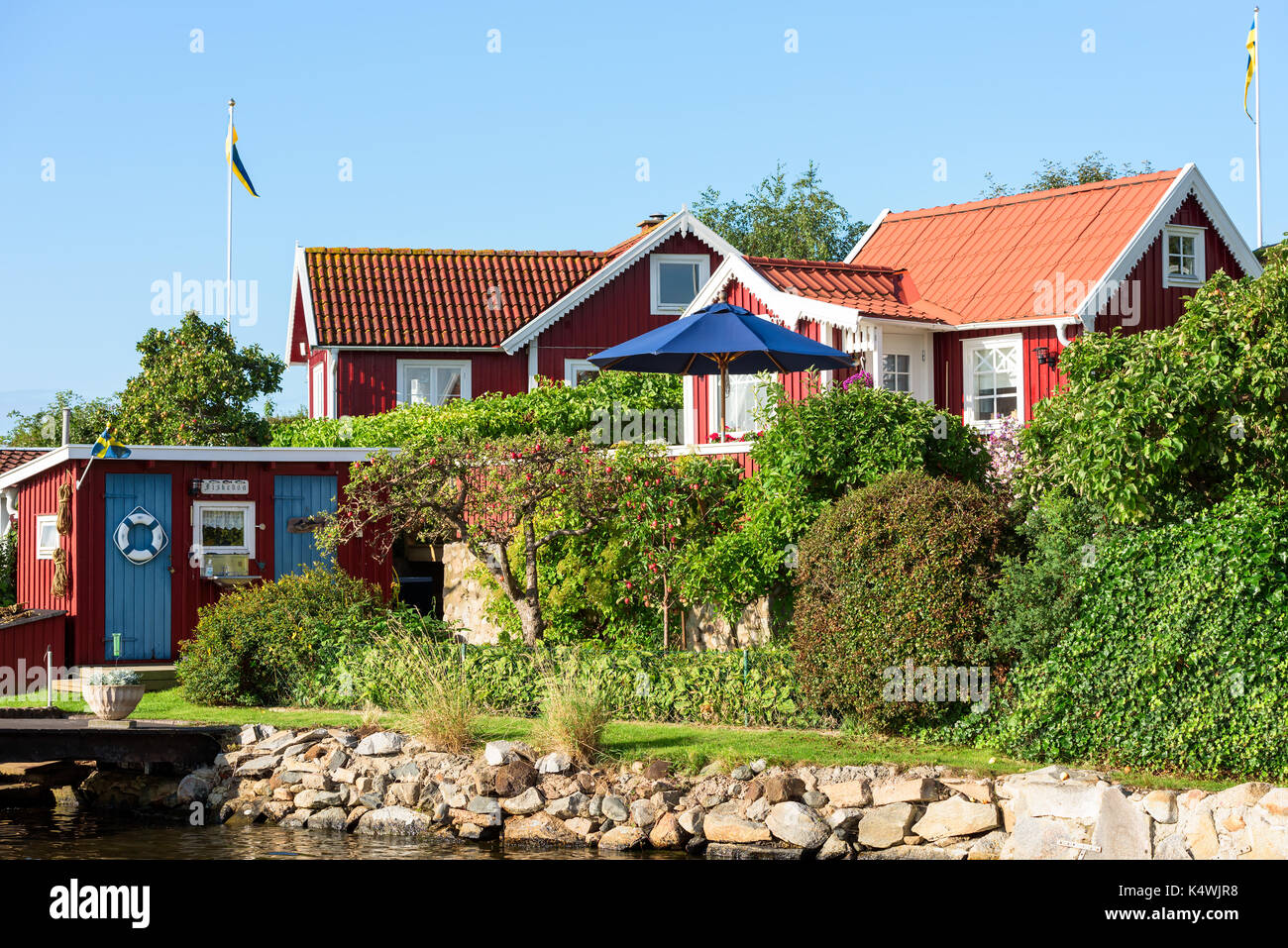 Karlskrona, Sweden - August 28, 2017: Travel documentary of the city surroundings. Seaside garden in coastal allotment area with red and white cabins  Stock Photo
