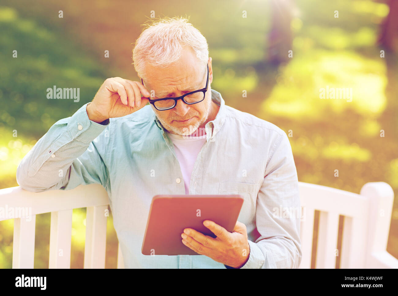senior man with tablet pc at summer park Stock Photo