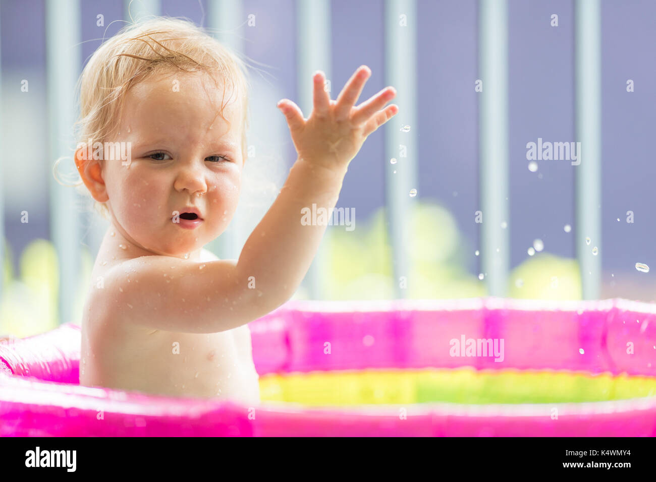 18 months old baby girl playing in inflatable pool Stock Photo Alamy
