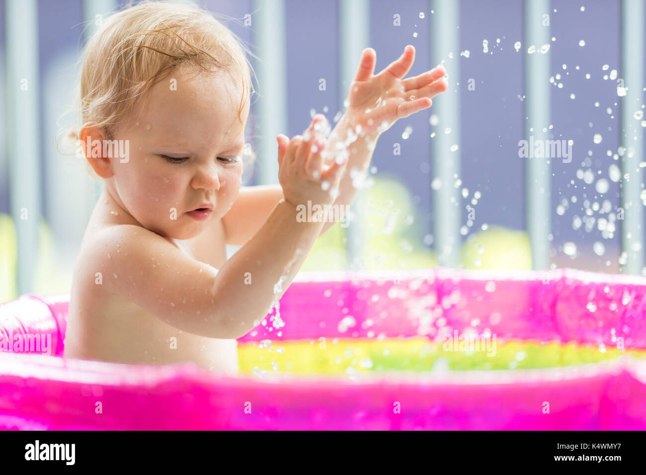 18 months old baby girl playing in inflatable pool Stock Photo Alamy