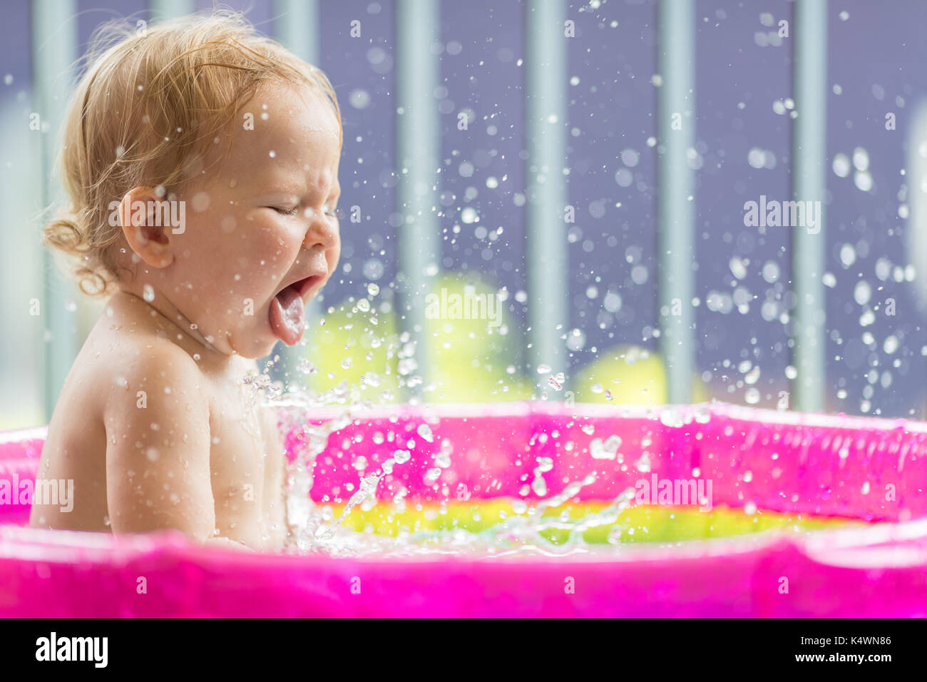 18 months old baby girl playing in inflatable pool Stock Photo Alamy